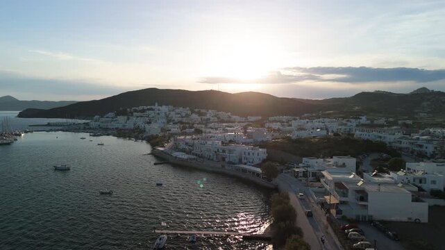 Rising drone flight during sunset over the village of Pollonia in the Island of Milos, Greece revealing the greek scenery
