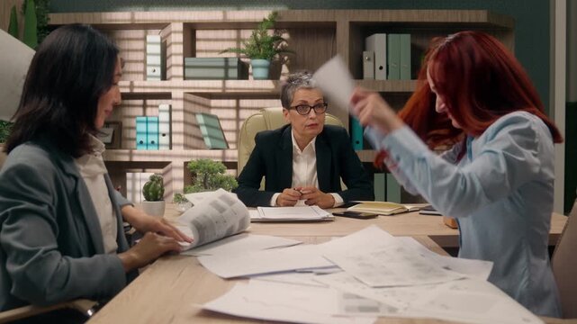 Three multiracial businesswomen quarrel in office briefing throwing papers team arguing nervous bad business data throw documents hit table argue females diversity women failure partnership stress