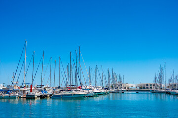 Fototapeta premium Marina with Boats and Yachts on Calm Sea in Summe