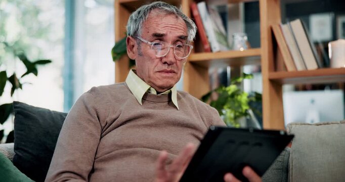 Glasses, surprise and tablet with old man on sofa in living room of home for reading or scrolling. App, eyewear and research with shocked senior at apartment for internet browsing or retirement