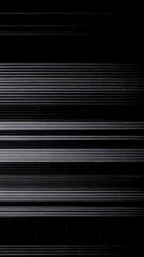 Glitchy analog video noise with tearing scan lines. Distorted broadcast signal for retro horror background. Dark screen effect with static interference artifact. Vertical video