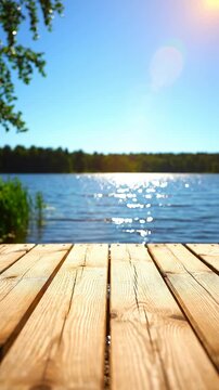 Sunny lake view from wooden dock with blue water and clear sky
