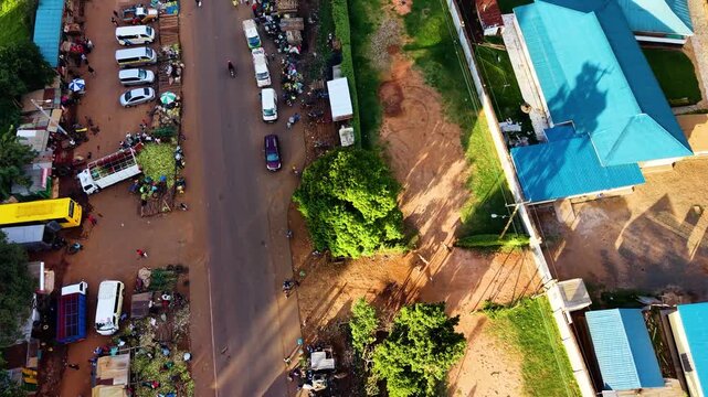 kenya roads, rural roads, poor rural settlement, damaged road with drone tracking vehicles over the road in the air.
