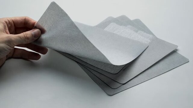 Medium shot of carrier sheets with functional antislip coating demonstrating ease of handling and improved friction during packaging