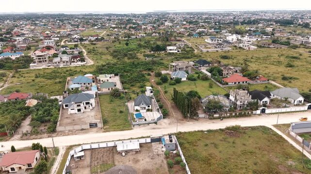 Aerial view of Kibada&ndash;Kigamboni in Dar es Salaam showcasing rural settlement patterns, housing development, and human architecture.