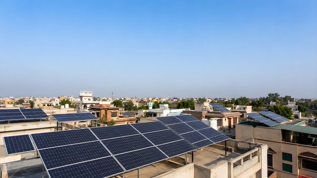 Wide Rooftop Solar Panels Over Pakistani City Homes With Clean Copy Space