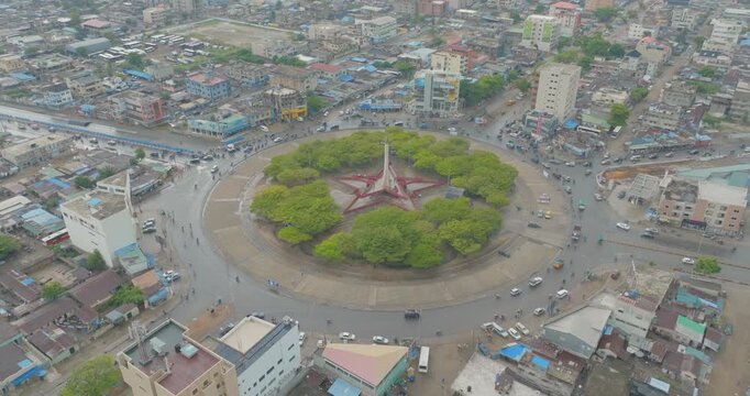 High-quality 4K aerial drone footage showcasing a busy roundabout in Cotonou, Benin Republic, with continuous vehicle movement and urban traffic flow. Captured from above, this cinematic cityscape