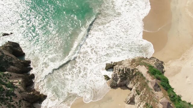 Maruata coastline with turquoise Pacific Ocean waters, white sand beaches, rugged limestone cliffs, rocky outcrops, and lush coastal mountains near Maruata, Michoac&aacute;n, Mexico.