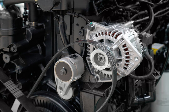 Close-up of a disassembled diesel internal combustion engine. Replacing the alternator belt.