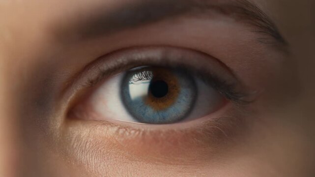 Cinematic Close-up of a Woman's Blue Eye with Soft Light Reflection, Detailed Iris and Pupil in Full HD Macro Shot