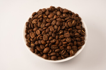 Fototapeta premium Coffee beans on a white background. Top view. Coffee beans texture.
