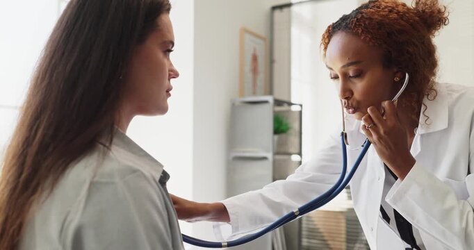 Doctor patient stethoscope clinic healthcare examination consultation. Physician uses stethoscope during checkup, providing accurate diagnosis and supportive care. Clear concept of patient care.