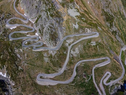 Aerial view of the winding Tremola road and its iconic hairpin turns on the Gotthard Pass in Airolo, Ticino, Switzerland.