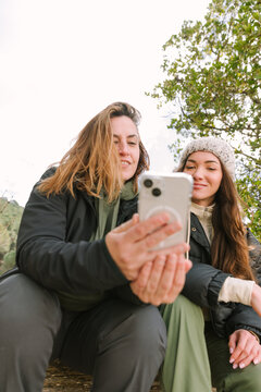 Hikers checking smartphone during winter mountain break