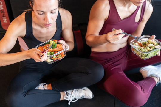 Healthy meal prep lunch for two women after gym workout