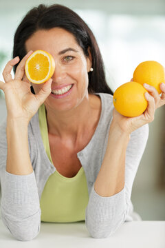 beauty woman with orange citrus on her eye