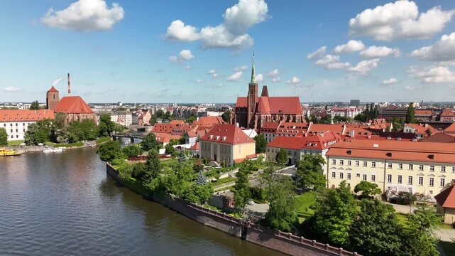 Aerial footage of the river and the city center of Wroclaw. Collegiate Church of the Holy Cross and St. Bartholomew