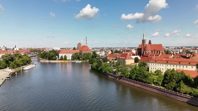 Aerial footage of the river and the city center of Wroclaw. Collegiate Church of the Holy Cross and St. Bartholomew