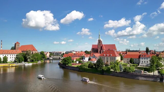 Aerial footage of the river and the city center of Wroclaw. Collegiate Church of the Holy Cross and St. Bartholomew