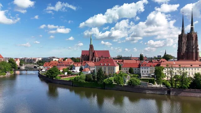 Aerial footage of the river and the city center of Wroclaw. Collegiate Church of the Holy Cross and St. Bartholomew