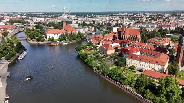 Aerial footage of the river and the city center of Wroclaw. Collegiate Church of the Holy Cross and St. Bartholomew