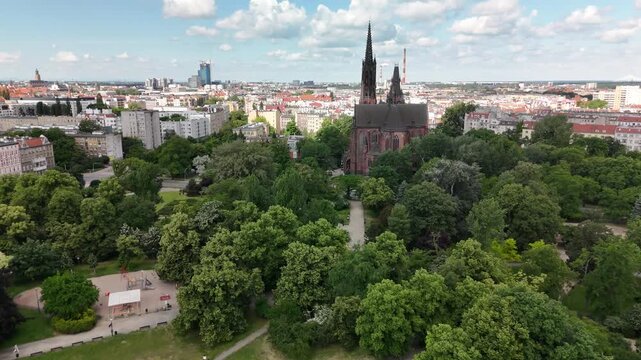Aerial view of city park with green trees Gothic church and urban skyline in Wrocław Poland
