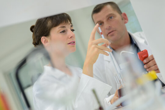 two scientists in laboratory doing a experiment