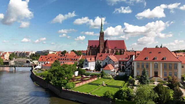 Aerial footage of the river and the city center of Wroclaw. Collegiate Church of the Holy Cross and St. Bartholomew