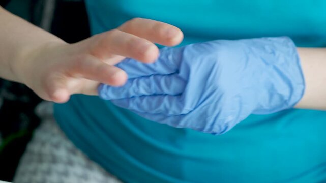 Woman applying soothing cream on painful thumb after computer work