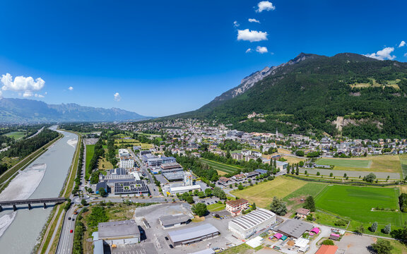 Aerial view of Vaduz Castle overlooking the city and the Rhine river valley under a clear blue sky with lush green mountains Vaduz, Vaduz, Liechtenstein.