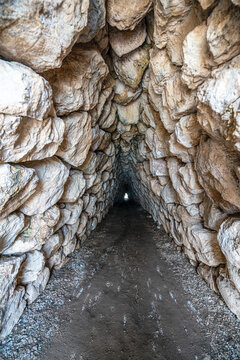 The historic stone postern tunnel beneath the Yerkapi rampart in the upper city of Hattusa. This defensive underground tunnel showcases the advanced military engineering and fortifications built by th