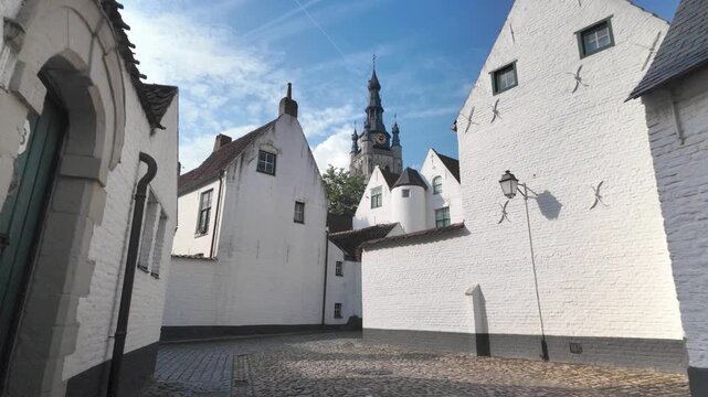 Historic UNESCO Kortrijk Belgium beguinage forward walking view along serene heritage lane, Belgium.