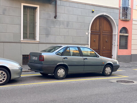Fiat Tempra sedan parked on an old European street, showcasing Italian automotive design and urban architecture