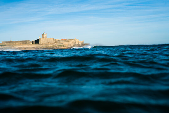 epic wave offshore wind in a blue sky  of Carcavelos beach Portugal