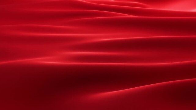 Slow motion panning shot of red silk fabric folding and flowing across smooth satin surface close up with subtle light reflections and soft undulating waves