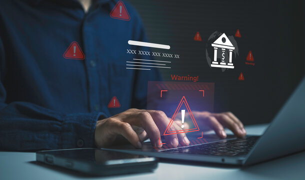 Cybersecurity warning for online banking user monitoring digital financial threats on laptop and smartphone to prevent fraud data breaches identity theft and secure banking transactions.