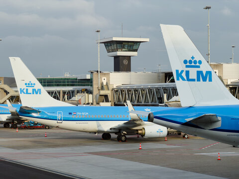 May 4, 2026, Amsterdam, Netherlands - KLM airplanes on the tarmac at Schiphol Airport with control tower in background