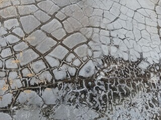 Cracked grunge concrete cement walls, building damage due to natural factors and age, walls need renovation, texture of cracks similar to fish scales © Sigit