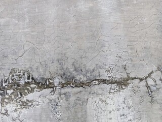 Obraz premium Cracked grunge concrete cement walls, building damage due to natural factors and age, walls need renovation, texture of cracks similar to fish scales