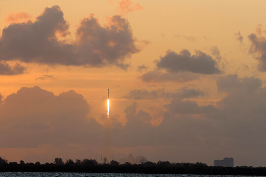 Falcon 9 Ascending Through Sunrise Clouds Over Florida
