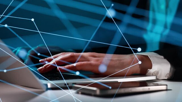 Hands typing on laptop while digital lines and shapes show connectivity in a modern workspace during evening hours