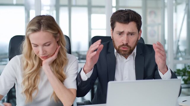 Two business partners with laptop Caucasian mature businessman feeling heart attack cardio health problem reading bad news in computer businesswoman blowing air with folder adult woman man in office