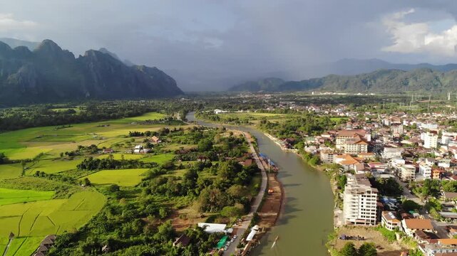 High altitude aerial drone shot over Vang Vieng river valley with karst mountains, Laos
