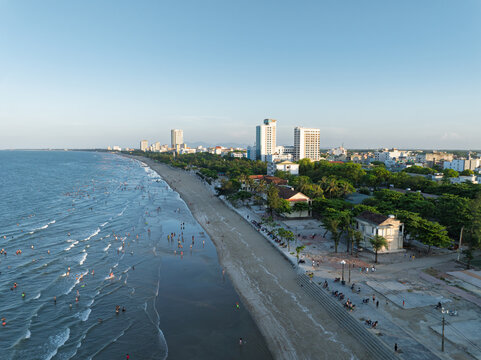 Aerial coastal scene of Cua Lo Beach crowded with visitors enjoying the shoreline during a calm afternoon.
