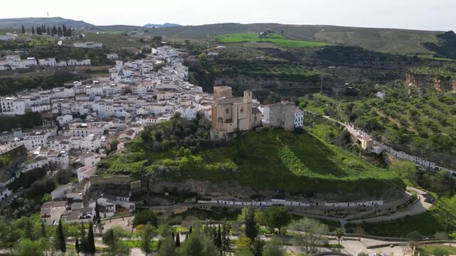 Aerial drone orbit around church in Setenil de las Bodegas, Andalusia, Spain
