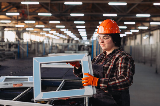 Woman inspecting pvc window frame in manufacturing factory