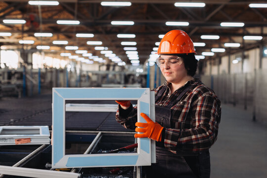 Woman worker assembling window frame in modern factory