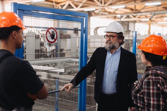 Manufacturing manager instructing workers about factory safety
