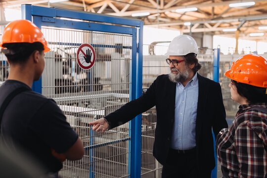 Engineering team discussing safety protocols at factory
