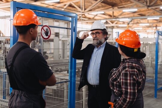 Manager discussing production with factory workers
